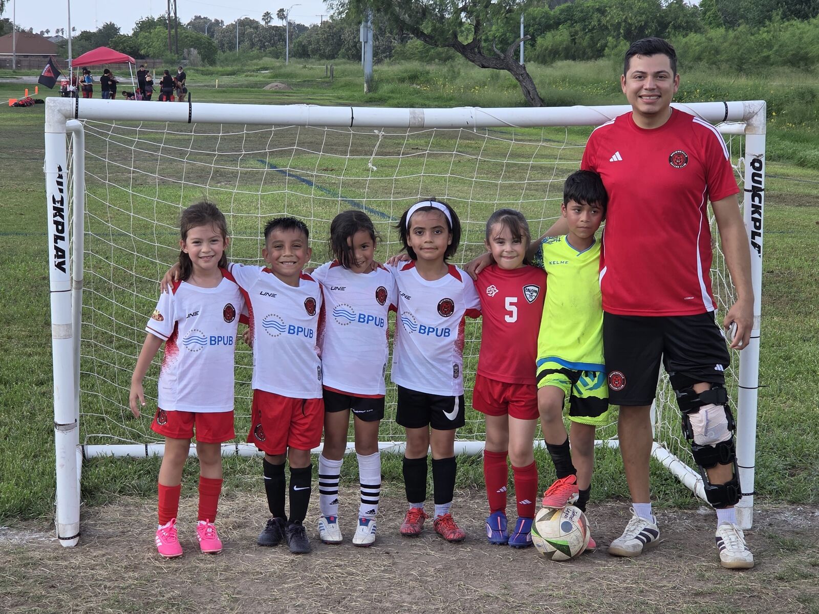 Mini BTX players with their coach
