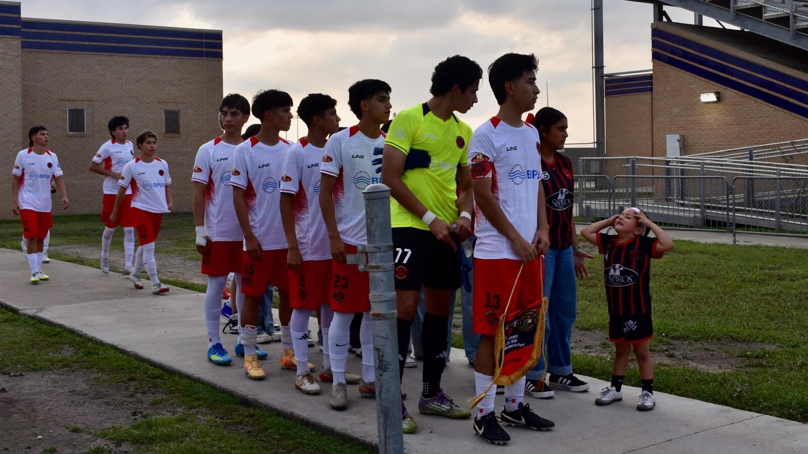 Semi-Pro players and kids lined up before a home game